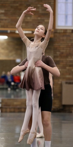 Young dancer being lifted into the air