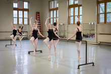 ballet dancers warming up in dance studio
