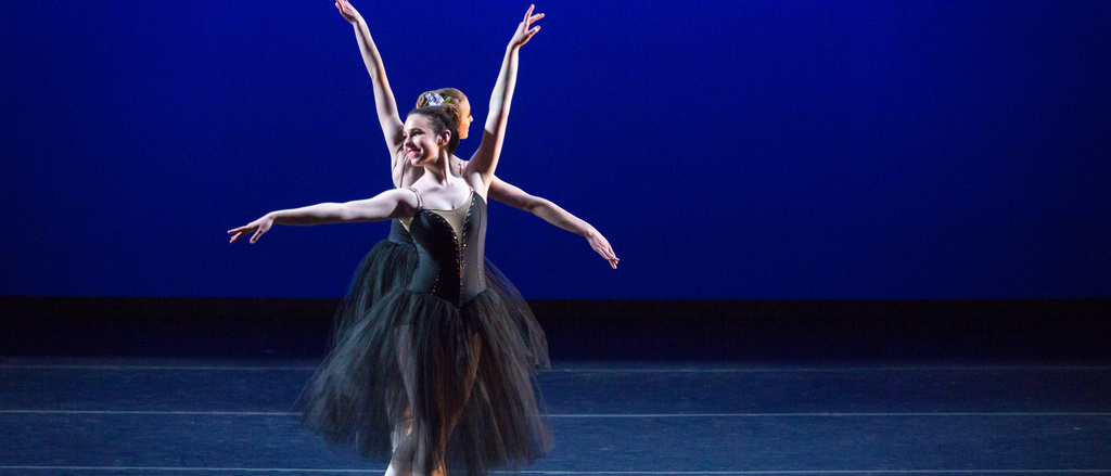 two ballet dancers standing next to each other